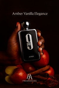 Dark-skinned hand holding Afnan 9PM Eau De Parfum bottle surrounded by apples, cinnamon sticks, and amber glow, with HA Fragrances logo and elegant nighttime aesthetic.