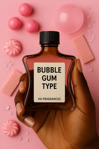 A dark-skinned hand holds a brown glass bottle labeled “Bubble Gum Type – HA Fragrances” against a pink background with bubble gum pieces, round candies, peppermint swirls, and sugar crystals.