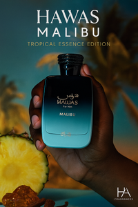Dark-skinned hand holding Rasasi Hawas Malibu Eau De Parfum bottle – Tropical Essence Edition, displayed with pineapple slices, amber stones, and palm background – HA Fragrances branding.