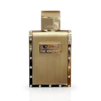 A close-up of The Kingdom Eau De Parfum bottle by Lattafa, featuring a luxurious gold design with sleek lines and crystal accents, exuding elegance and sophistication.