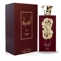 Ansaam Gold Eau de Parfum 100mL by Lattafa Pride – A luxurious fragrance in an elegant maroon and gold bottle with floral detailing.