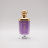 Bharara Enchanted 3.4 oz Eau De Parfum bottle – elegant unisex fragrance with purple liquid and gold cap.